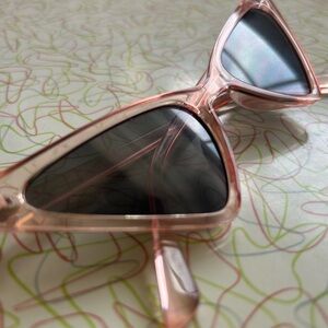 Clear, pink, dramatic cat eye retro style sunglasses
